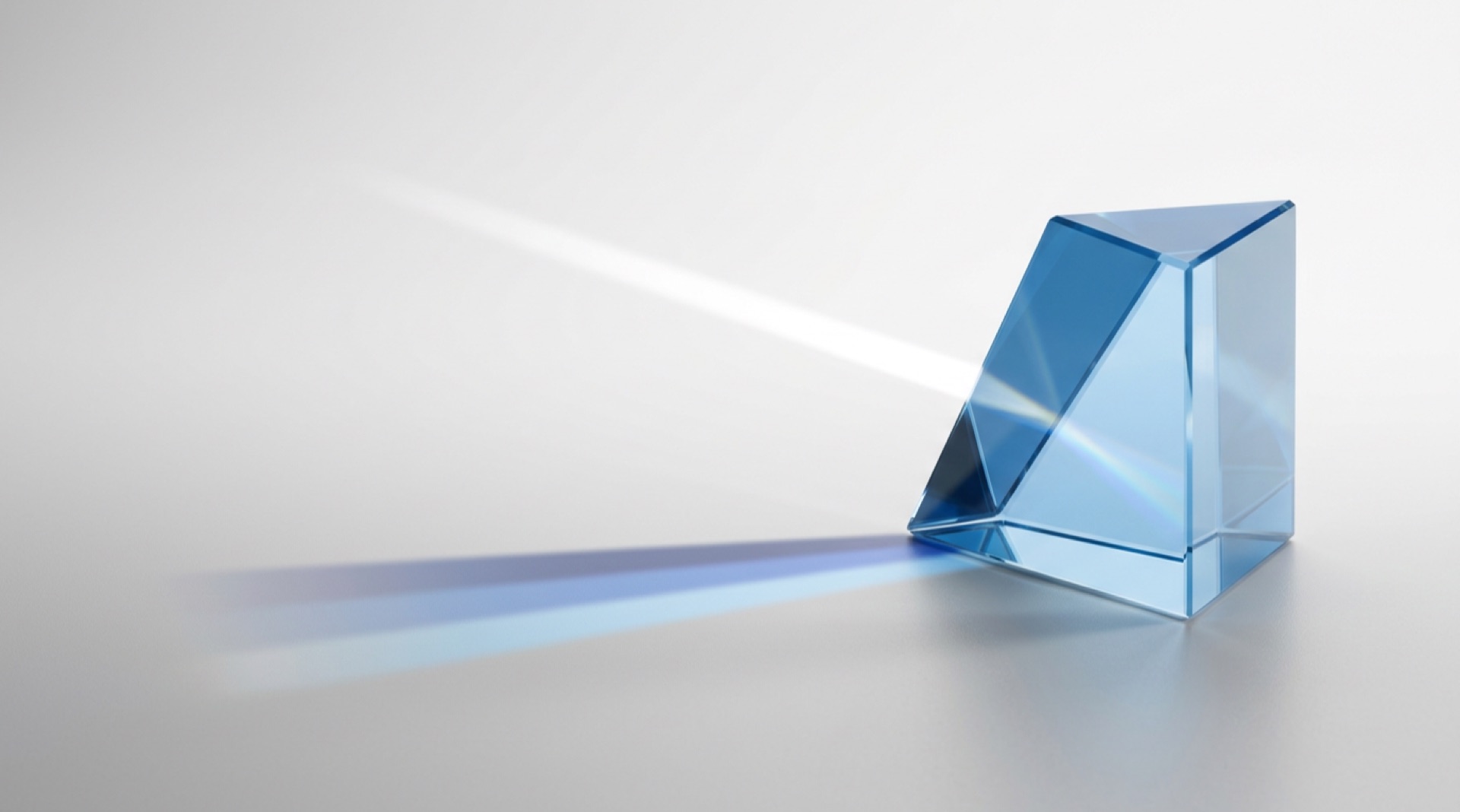 Glass prism turning light into blue bands, representing specialist knowledge becoming organisational capability in professional services
